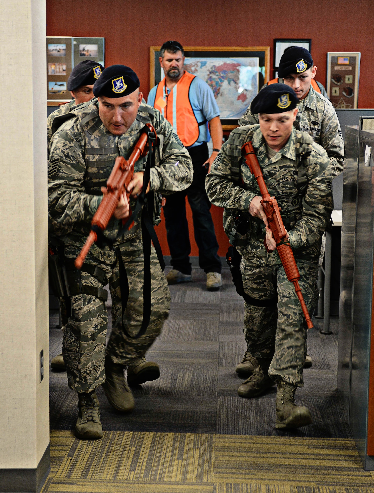 Airmen assigned to the 28th Security Forces Squadron sweep through a building during an active shooter exercise at Ellsworth Air Force Base, S.D., Aug. 12, 2014. The exercise tested the ability of the 28th SFS and other first responders to react to active shooter scenarios. (U.S. Air Force photo by Senior Airman Zachary Hada/Released)