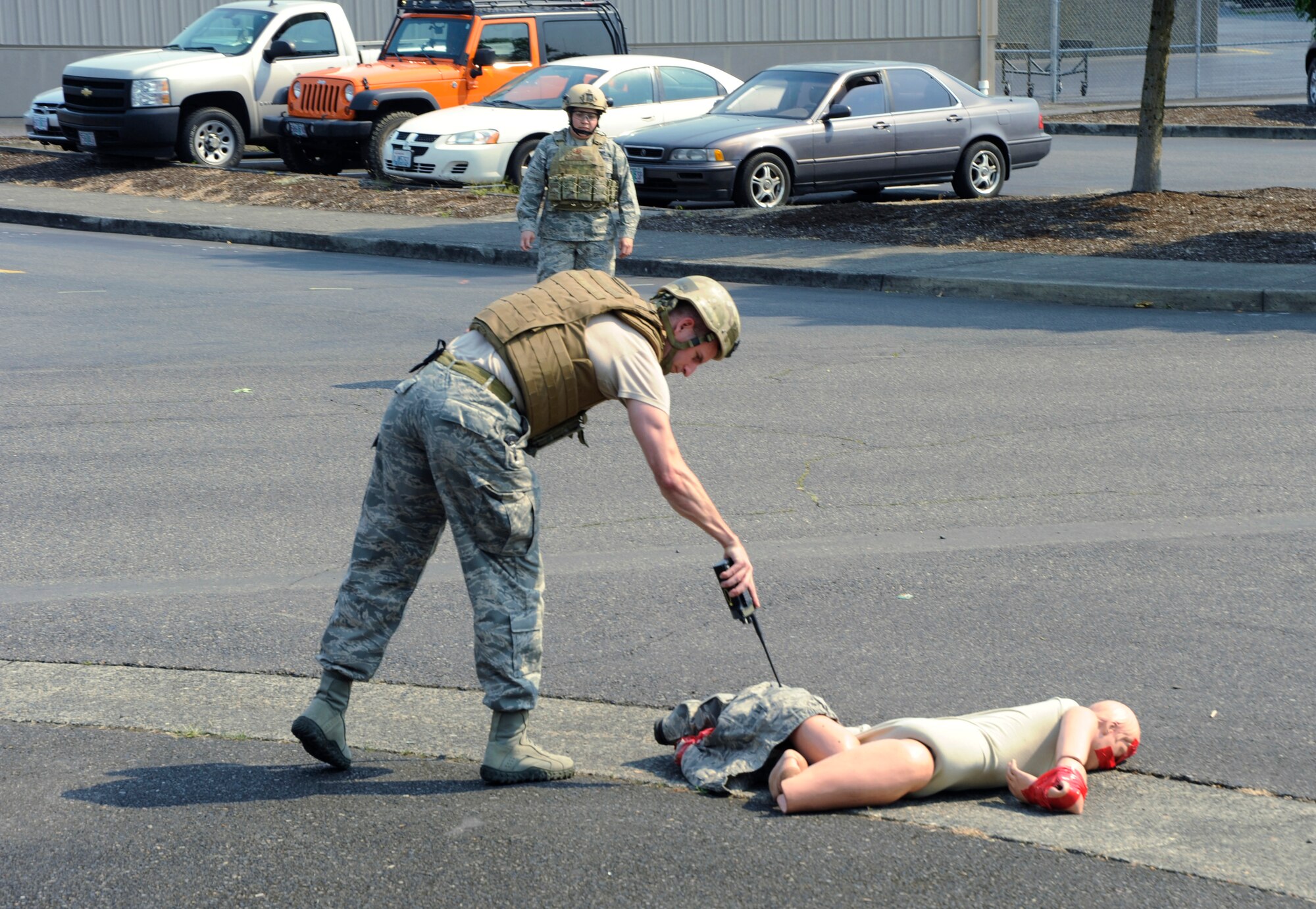 Master Sgt. Waymon Hubbard, an Explosive Ordinance Disposal specialist, assigned to the 142nd FW Civil Engineer Squadron, inspects a training mannequin during a base exercise conducted by the Wing Inspection Team, Portland Air National Guard Base, Ore., Aug. 2, 2014. The exercise scenario had one individual detonated after moving a box from the roadway. (U.S. Air National Guard Photo by Tech. Sgt. Aaron Perkins, 142nd Fighter 
Wing Public Affairs/Released)


