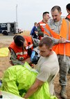 Beale medical personnel attend to a simulated patient during an emergency services exercise at Beale Air Force Base, Calif., Aug. 8, 2014. The exercise demonstrated how Team Beale would respond to a chemical, biological, radiological, nuclear and high-yield explosives attack. (U.S. Air Force photo by John Schwab/Released)