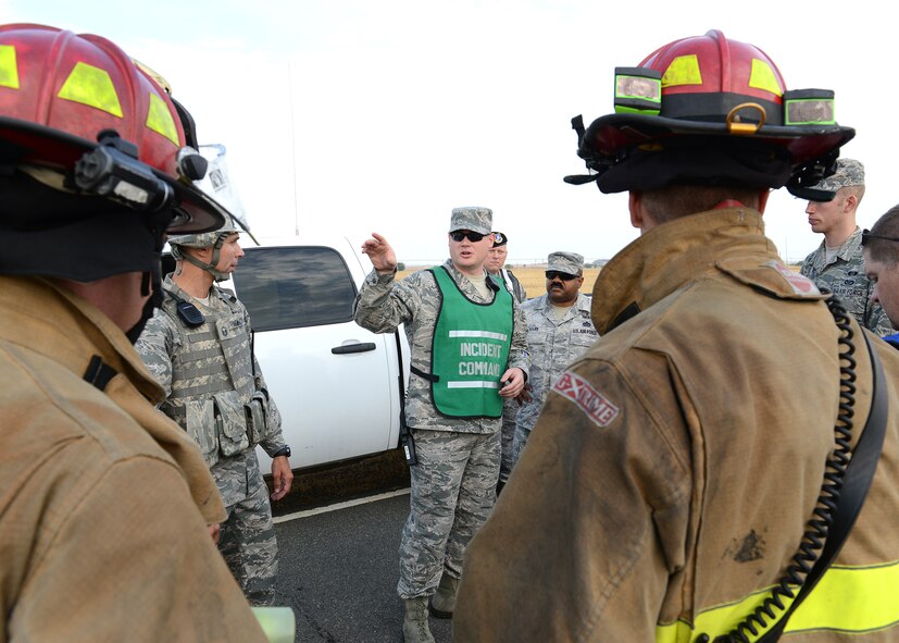 Beale emergency response personnel receive orders from the incident commander during a training exercise at Beale Air Force Base, Calif., Aug. 8, 2014. The exercise demonstrated how Team Beale would respond to a chemical, biological, radiological, nuclear and high-yield explosives attack. (U.S. Air Force photo by John Schwab/Released)
