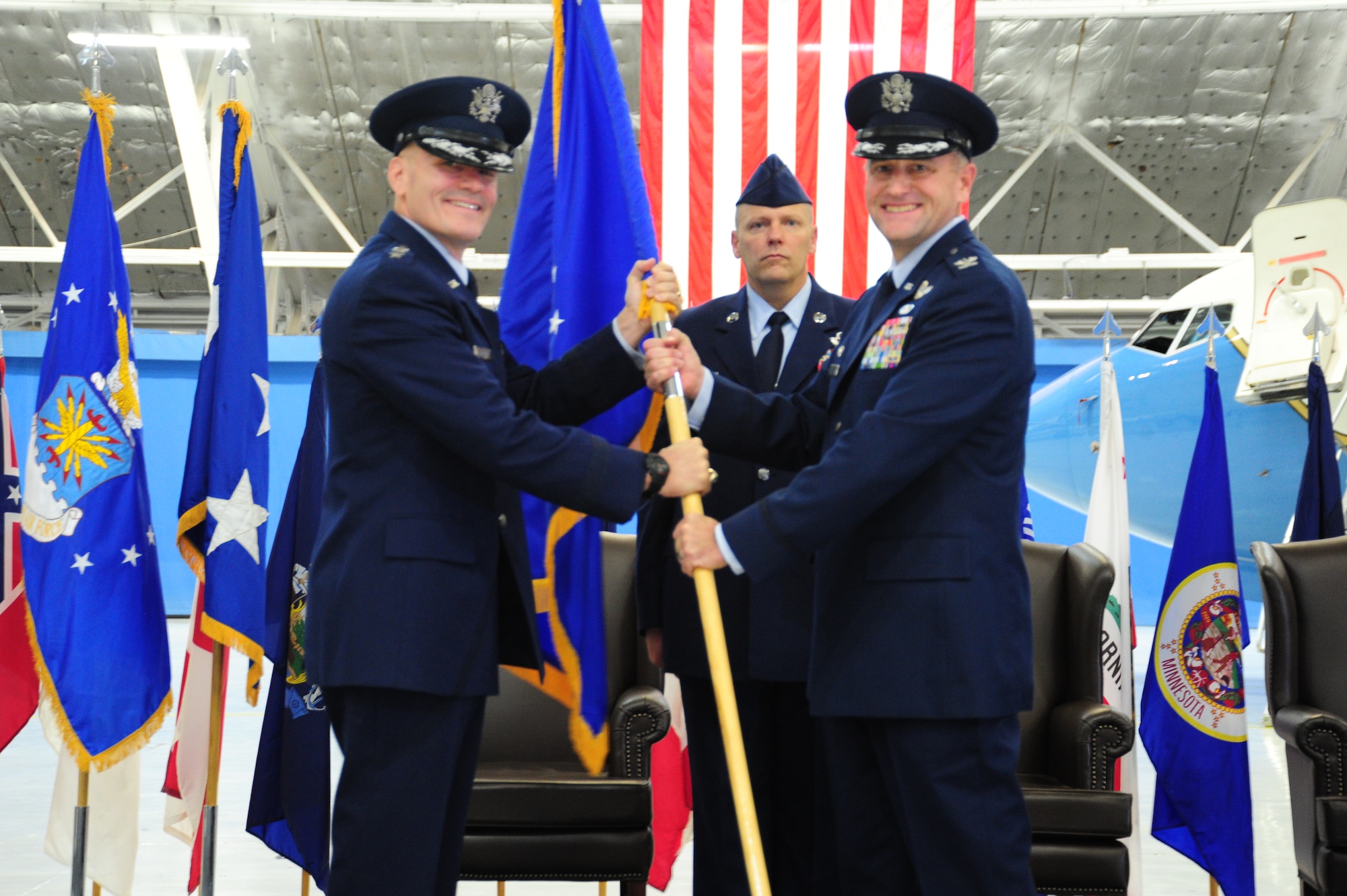 Lt. Gen. Carlton D. Everhart II, 18th Air Force commander, passes the respsonsibility of command of the 89 Airlift Wing to Col. John C. Millard at Joint Base Andrews, Md., Aug 14, 2014. Millard assumed command from Col David L. Almand after serving as the commander of the 376th Expeditionary Wing, Transit Center Manas, Kyrgyz Republic. (U.S. Air Force photo/Airman 1st Class Joshua R. M. Dewberry) 