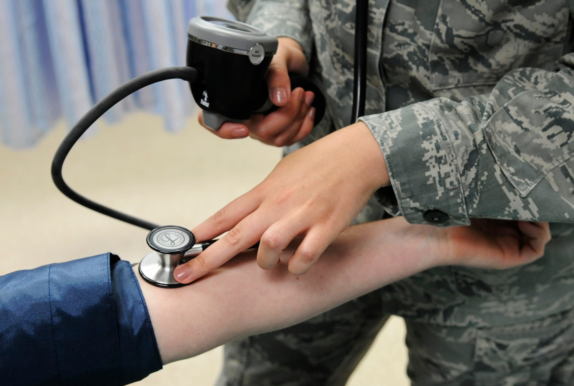 Senior Airman Alexandria Denio, 366th Medical Group Urgent Care Center aerospace medical technician, takes a blood pressure reading, Aug. 1, 2014, at Mountain Home Air Force Base, Idaho. Remaining open even when the MDG closes for holidays, training and other official functions, the UCC sees and treats anyone who feels the need to be seen - at any time for any reason. (U.S. Air Force photo by Senior Airman Caitlin Guinazu/RELEASED) 

