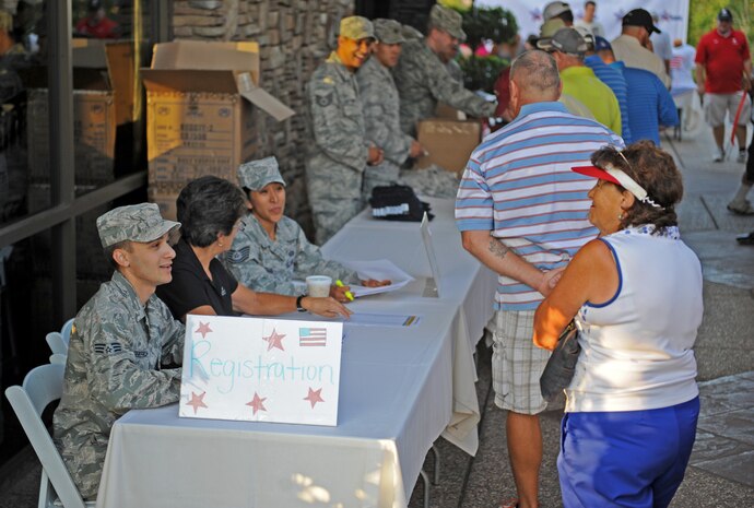 The 13th Reconnaissance Squadron assists with golfers registration at the World's Largest Golf Outing, benefiting the Wounded Warrior Project, Aug. 11, 2014, at Lincoln Hills Golf Club in Lincoln, Calif. The Lincoln Hills Golf Club contributed $11,487 in donations to add to the nation-wide total of $748,805. (U.S. Air Force photo by Airman 1st Class Ramon A. Adelan/Released)