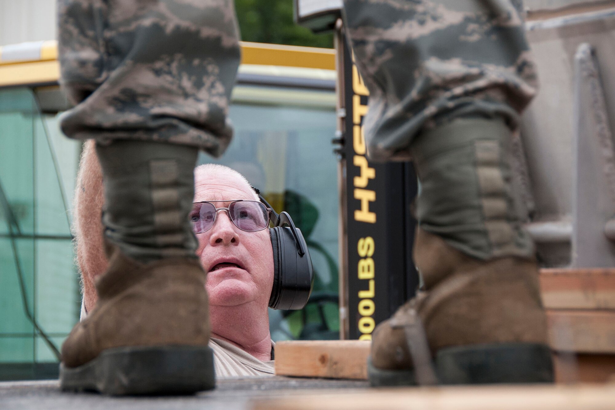 U.S. Air Force Tech. Sgt. John Carter, the 307th Maintenance Squadron’s munitions storage shop chief, hands a crowbar to an Airman to assist in prying apart boards holding a Training Guided Missile (TGM) container on a flat-bed trailer in the munitions storage area at Barksdale Air Force Base, La., July 24, 2014. The TGM is just one on the 260 different line items the storage crew members assigned to the 307 MXS are responsible for on a daily basis. (U.S. Air Force photo by Master Sgt. Jeff Walston/Released)