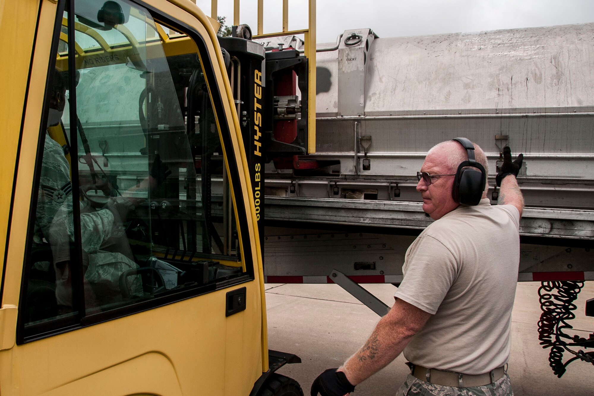 U.S. Air Force Tech. Sgt. John Carter, the 307th Maintenance Squadron’s munitions storage shop chief, supervises the unloading of a Training Guided Missile (TGM) from a flat-bed trailer in the munitions storage area at Barksdale Air Force Base, La., July 24, 2014. The TGM is just one on the 260 different line items the storage crew members assigned to the 307 MXS are responsible for on a daily basis. (U.S. Air Force photo by Master Sgt. Jeff Walston/Released)