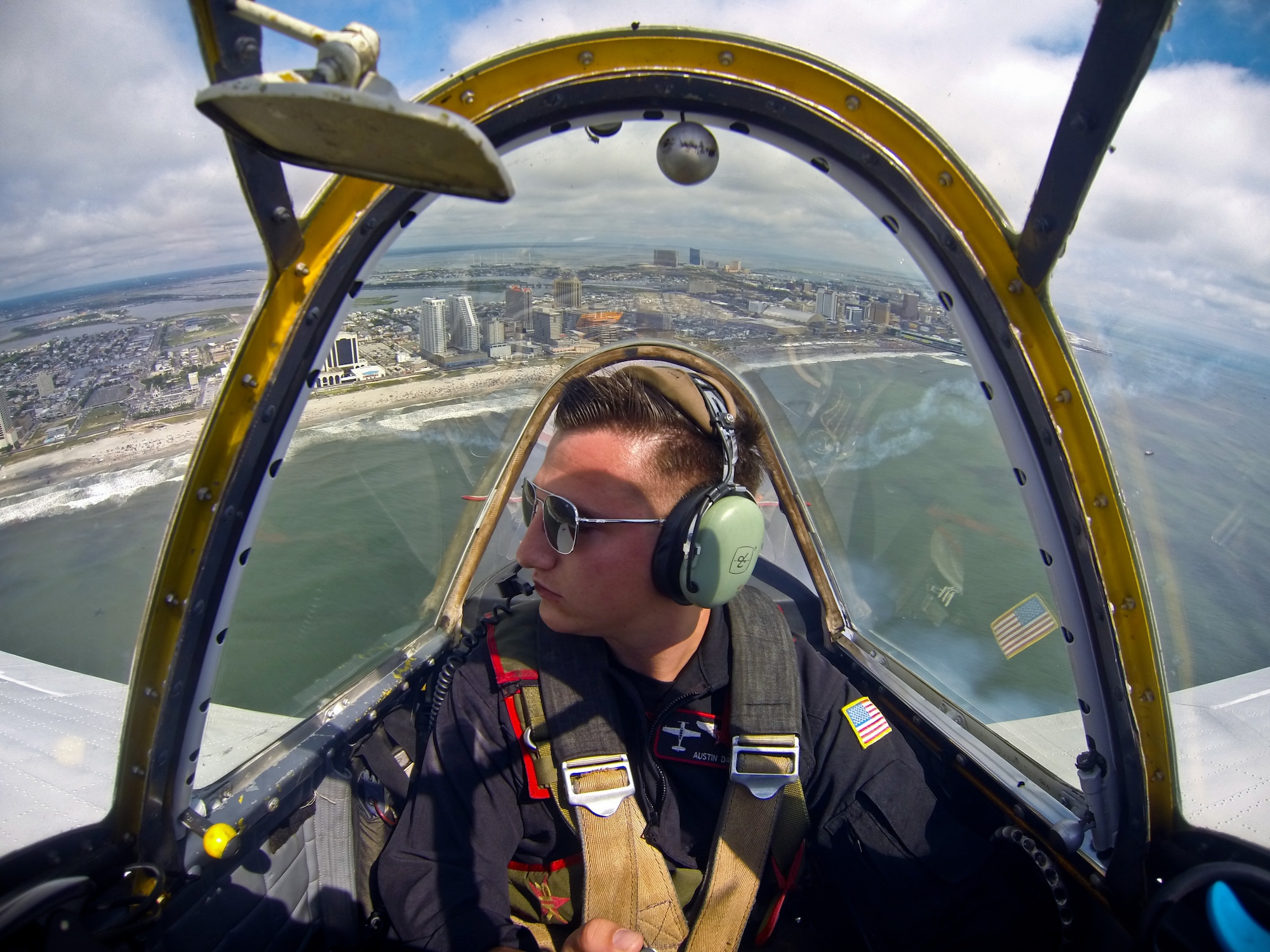 A picture of Austin Daniel, an Airman with the New Jersey Air National Guard's 177th Fighter Wing, flying with the Raiders Demonstration Team in his Yak-52 demonstration aircraft.