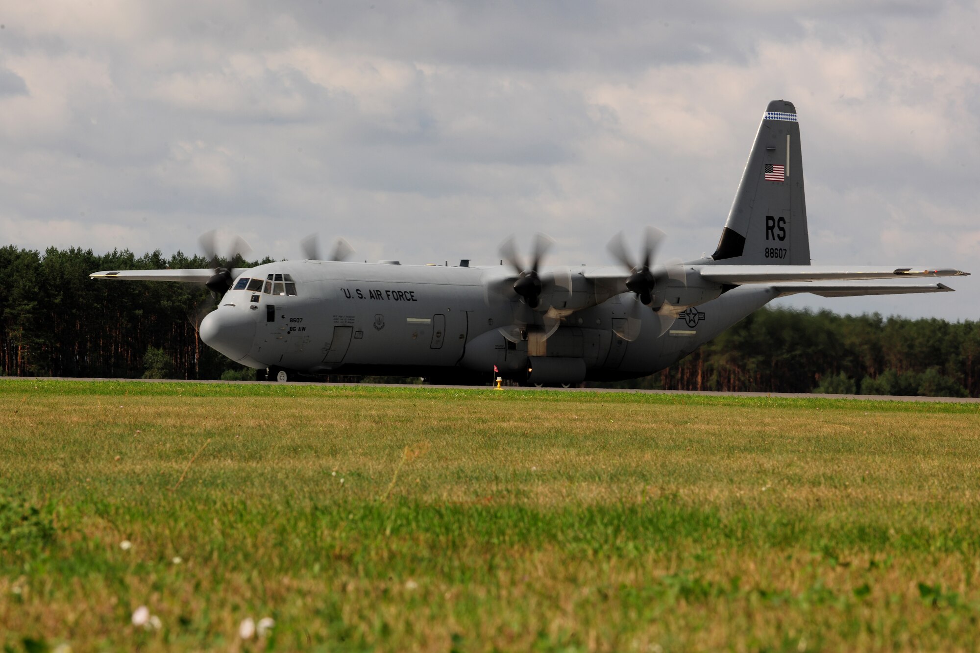 A C-130J Super Hercules, deployed from Ramstein Air Base, Germany, taxis down the runway after landing at Powidz Air Base, Poland, Aug. 14, 2014. Both the aircraft and the Airmen in tow represent America’s forward presence in Europe. (U.S. Air Force photo by Staff Sgt. Jarad A. Denton/Released)