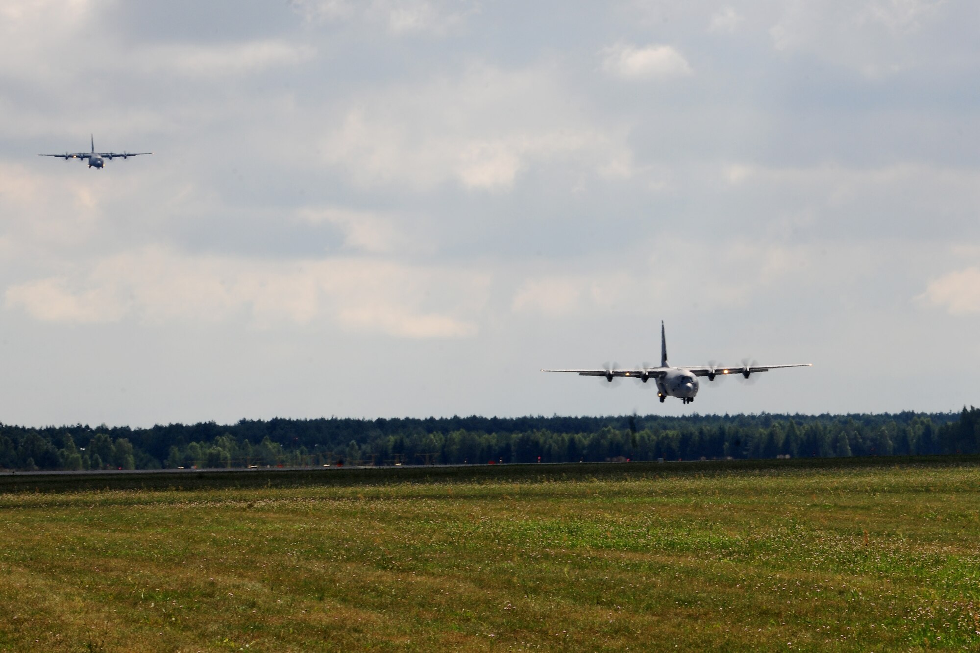 Two C-130J Super Hercules aircraft come in for a landing at Powidz Air Base, Poland, Aug. 14, 2014. The aircraft, deployed from Ramstein Air Base, Germany, are part of a flying training deployment in support of Operation Atlantic Resolve. (U.S. Air Force photo by Staff Sgt. Jarad A. Denton/Released)