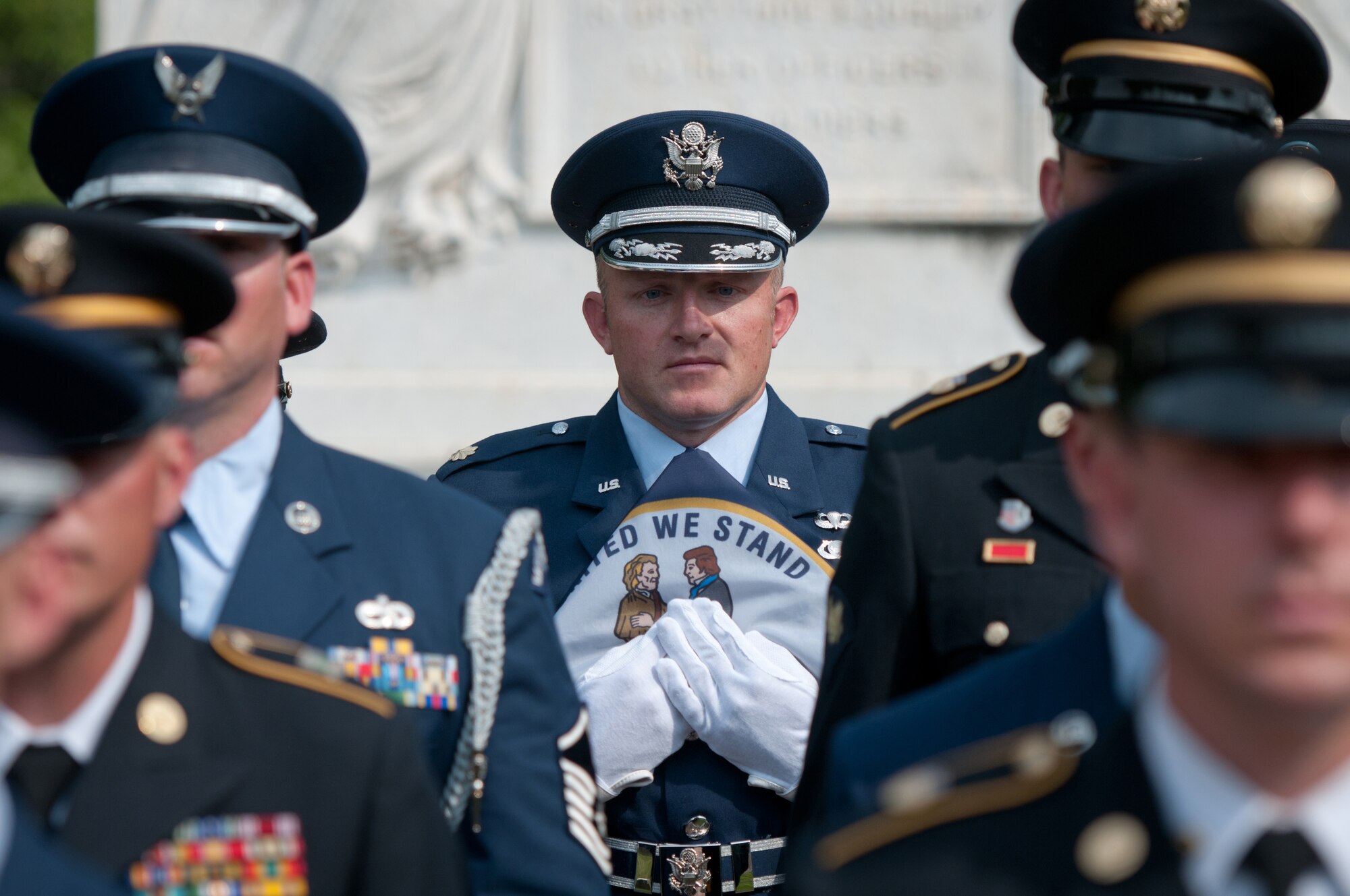 Maj. Josh Elwell, officer-in-charge of the 123rd Airlift Wing Honor Guard Team, carries the Kentucky state flag while drilling with a joint-service Color Guard Team comprised of Kentucky Air and Army National Guard members at Frankfort Cemetery in Frankfort, Ky., on Aug. 5, 2014, while being videotaped by CBS Sports for a television spot. The spot was broadcast during the network’s national coverage of the Professional Golfers’ Association of America Championship at Valhalla Golf Club in Louisville, Ky., Aug. 4-10. (U.S. Air National Guard photo by Master Sgt. Phil Speck)