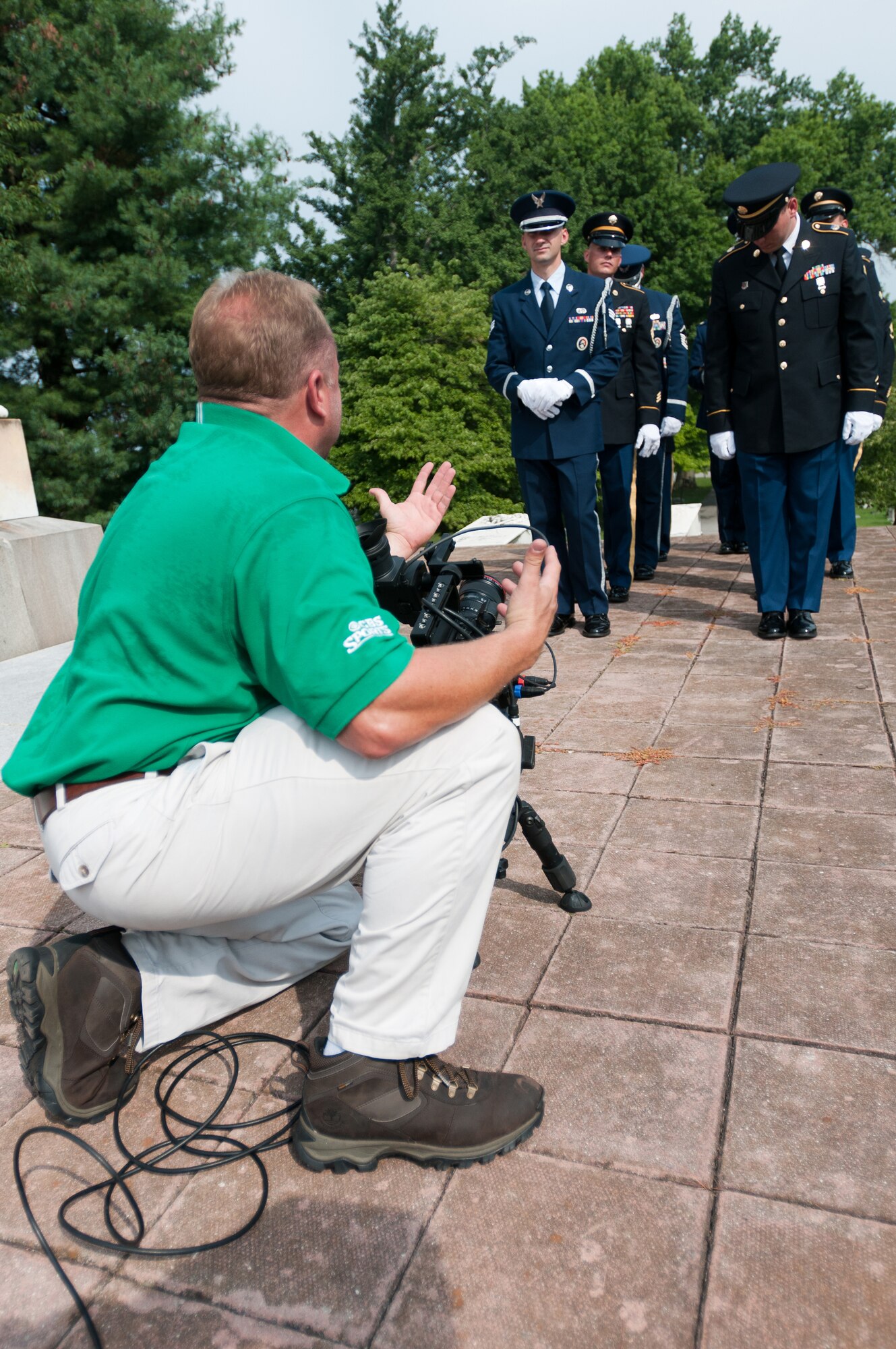 A CBS Sports videographer shoots footage of a joint-service Color Guard Team comprised of Kentucky Air and Army National Guard members at Frankfort Cemetery in Frankfort, Ky., on Aug. 5, 2014. The television spot was broadcast during the network’s national coverage of the Professional Golfers’ Association of America Championship at Valhalla Golf Club in Louisville, Ky., Aug. 4-10. (U.S. Air National Guard photo by Master Sgt. Phil Speck)