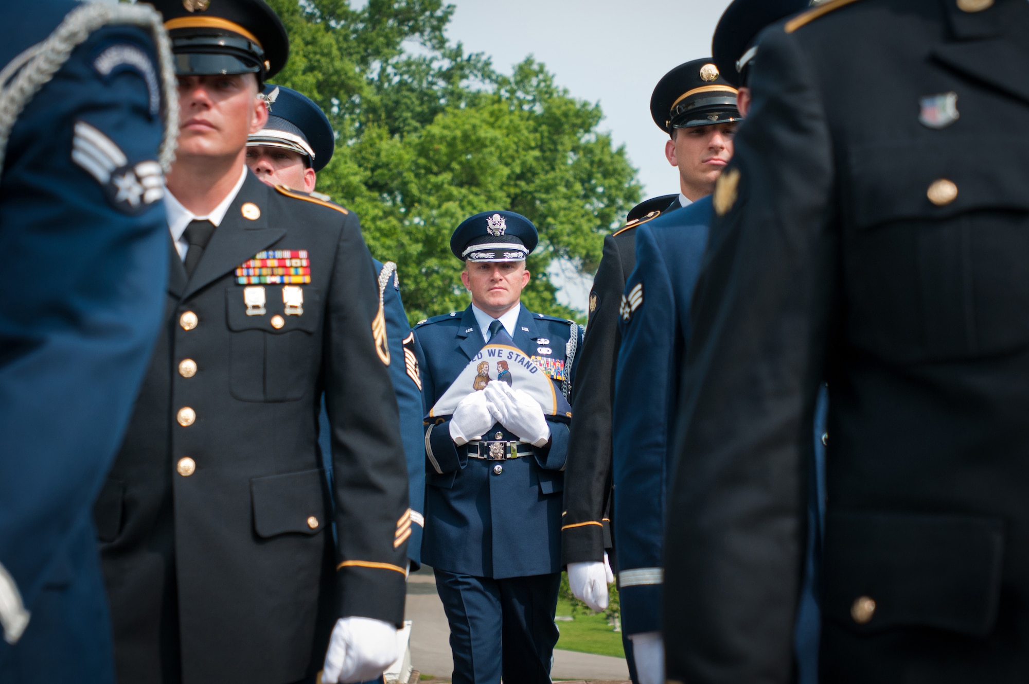 Maj. Josh Elwell, officer-in-charge of the 123rd Airlift Wing Honor Guard Team, carries the Kentucky state flag while drilling with a joint-service Color Guard Team comprised of Kentucky Air and Army National Guard members at Frankfort Cemetery in Frankfort, Ky., on Aug. 5, 2014, while being videotaped by CBS Sports for a television spot. The spot was broadcast during the network’s national coverage of the Professional Golfers’ Association of America Championship at Valhalla Golf Club in Louisville, Ky., Aug. 4-10. (U.S. Air National Guard photo by Master Sgt. Phil Speck)