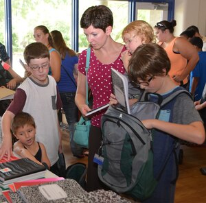 Shannon Bryson and her children (left to right) Delilah, Collin, Brigham and Landon, select school supplies for the upcoming school year Aug. 14, 2014, at the Balfour Beatty Military Housing Community Center on Joint Base Charleston, S.C. Working with Operation Homefront, volunteers from Balfour Beatty collected donations from Charleston Area Dollar Stores during a six week period and then donated the supplies to military children in the Joint Base Charleston area. Operation Homefront provides emergency financial and other assistance to the families of service members and wounded warrior s. (U.S. Air Force photo/Eric Sesit)