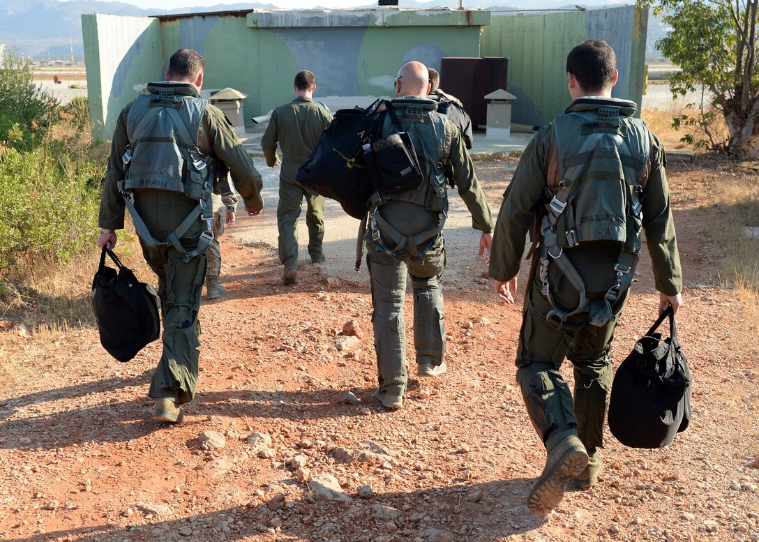 U.S. Air Force pilots walk toward the flightline Aug. 12, 2014, at a training event in Souda Bay, Greece. The Hellenic and U.S. air forces prepared more than 20 aircraft launches a day for this planned two-week bilateral training. (U.S. Air Force photo by Staff Sgt. Daryl Knee/Released)