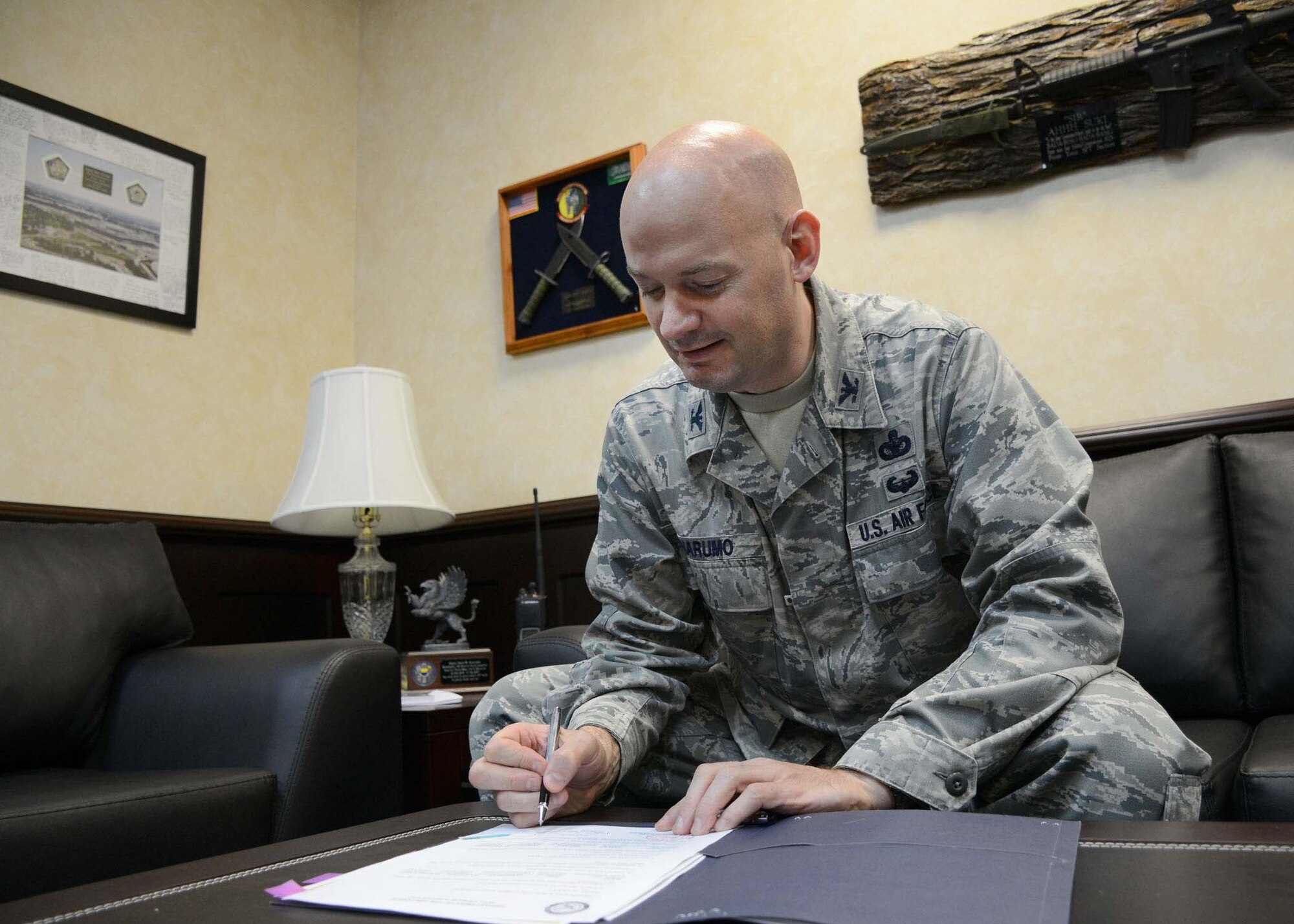 Col. Mark Anarumo, 39th Air Base Wing vice commander, sings off on various documents in his office Aug. 12, 2014, Incirlik Air Base, Turkey. Anarumo officially became the wings new vice commander on July 15, after serving at Headquarters U.S. Air Force, Washington D.C., as the programing branch chief. (U.S. Air Force photo by Staff Sgt. Veronica Pierce)