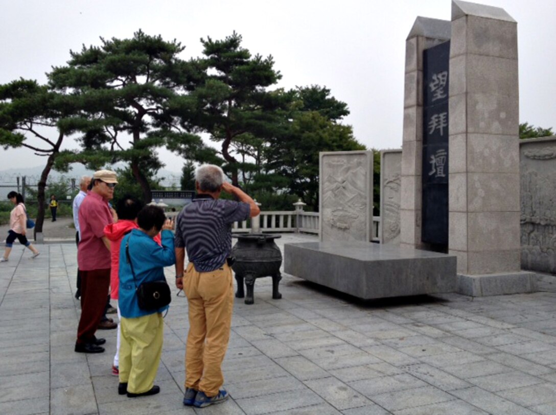 Visitors salute the War Memorial at Imjingak Park, Republic of Korea, Aug. 13, 2014. The memorial is the site of remembrance services held during Chuseok and the Lunar New Year for families who were separated as a result of the Korean War. (U.S. Air Force photo/Airman 1st Class Ashley J. Thum)