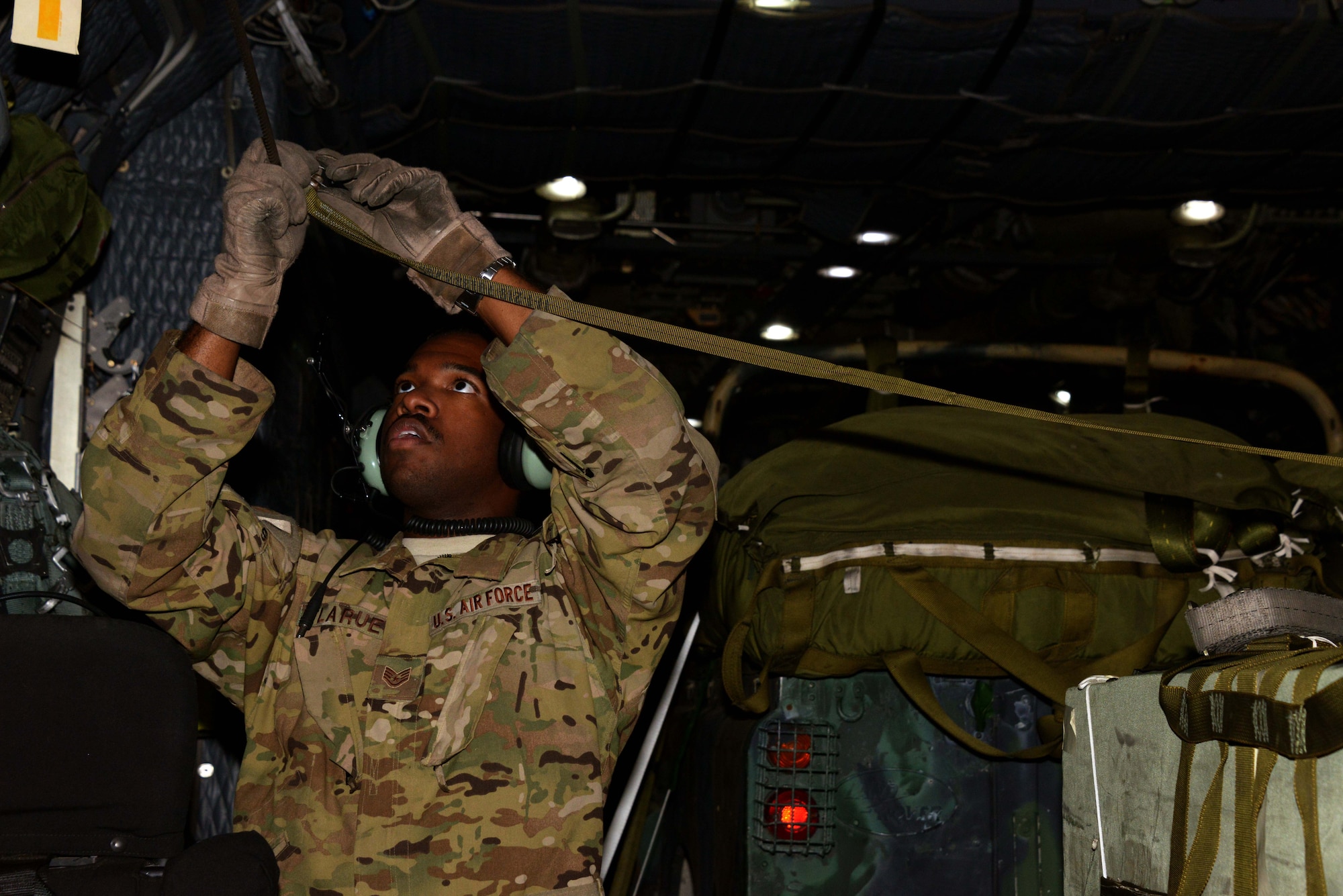Staff Sgt. Shaun LaRue, a loadmaster at the 1st Special Operations Squadron, rigs the static line for an air drop July 26, 2014 on an MC-130H Combat Talon II at Ohakea Air Base, New Zealand during Exercise Balance Net.  During the exercise, members from both the New Zealand Defense Force and U.S. Air Forces worked together to conduct personnel and equipment air drops while exchanging new techniques. This was the first time in almost three decades the group has deployed to New Zealand.  (U.S. Air Force photo by Tech. Sgt. Kristine Dreyer)