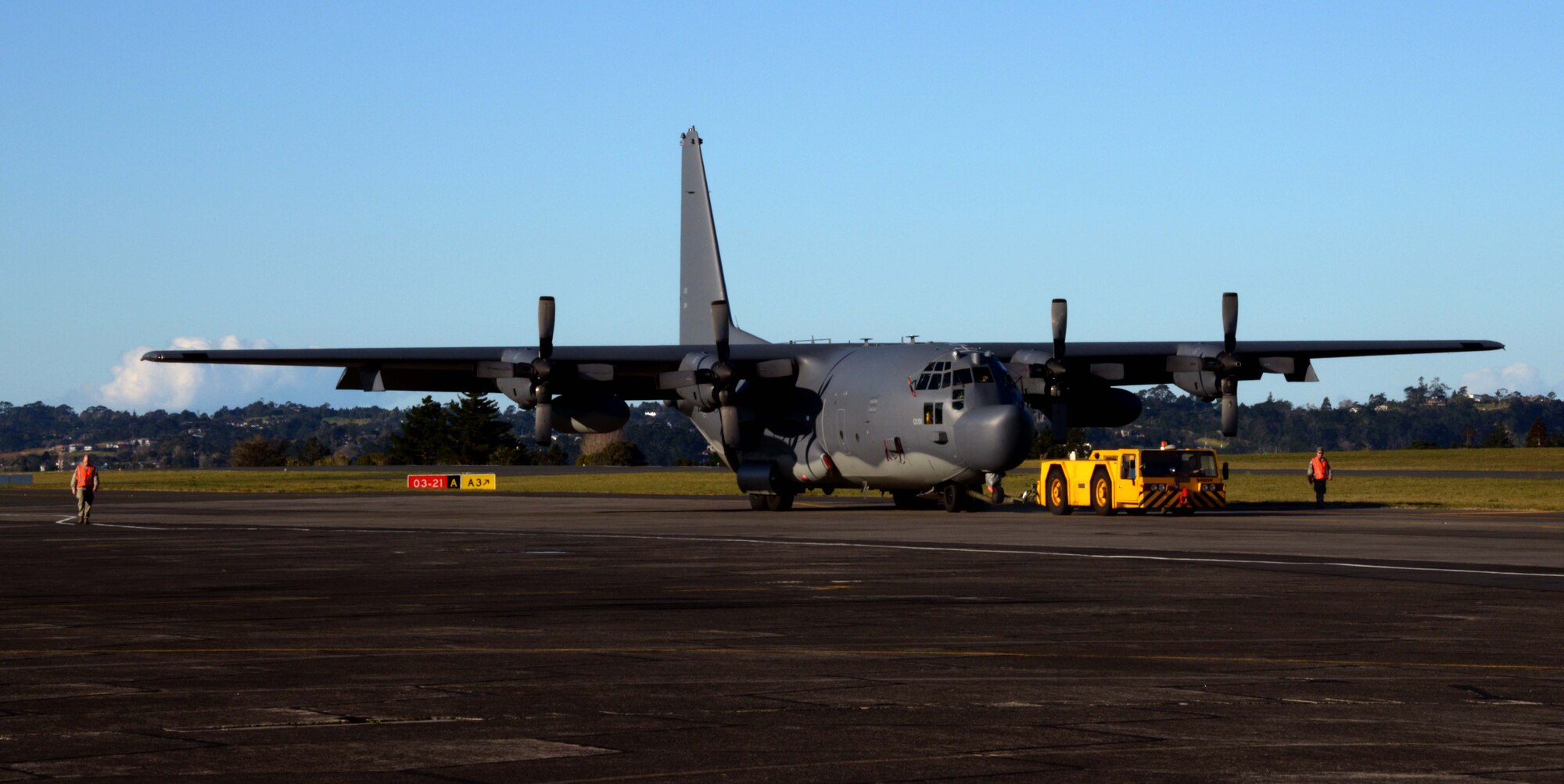 Maintainers from the 353rd Special Operations Maintenance Squadron and the New Zealand Defense Force work together to tow an aircraft during a periodic maintenance interval July 28, 2014 at Whenuapai Air Base, New Zealand. Members from the 353rd Special Operations Group participated in Exercise Balance Net July 17 through July 31 in Whenuapai, New Zealand.  During the exercise, members from both the New Zealand Defense Force and U.S. Air Forces worked together to conduct personnel and equipment air drops while exchanging new techniques. This was the first time in almost three decades the group has deployed to New Zealand.  (U.S. Air Force photo by Tech. Sgt. Kristine Dreyer)