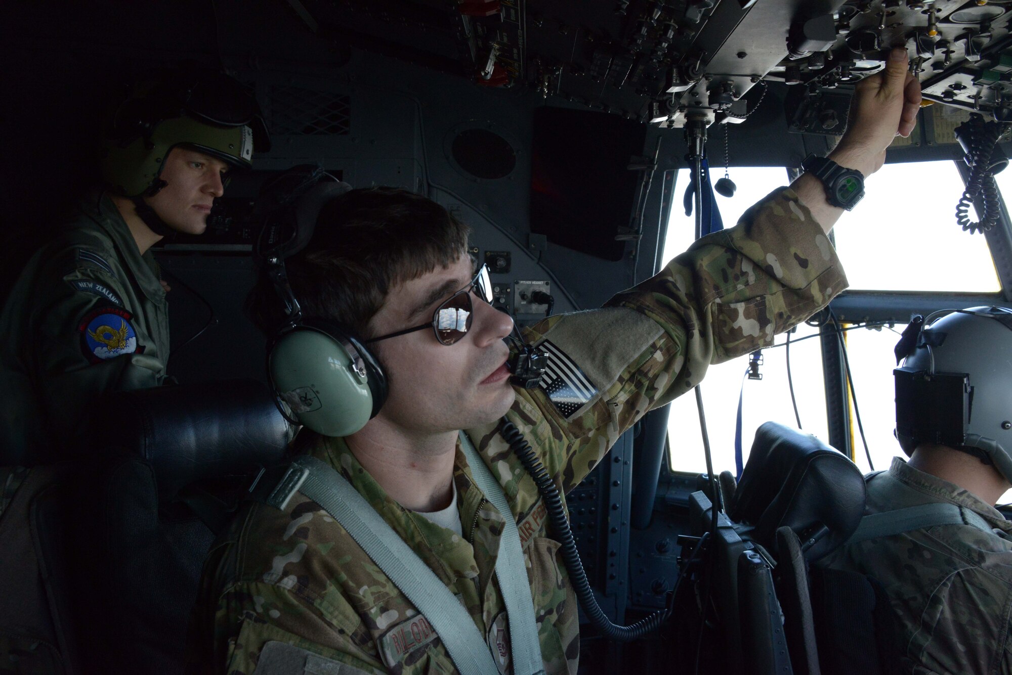 A member of the New Zealand Defense Force observes as Master Sgt. Jeremy Bilodeau, a flight engineer with the 1st Special Operations Squadron, adjusts the aircraft pressurization on an MC-130H Combat Talon II July 18, 2014 during Exercise Balance Net in New Zealand.  Members from the 353rd Special Operations Group participated in the exercise July 17 through July 31 in Whenuapai, New Zealand. During the exercise, members from both the New Zealand Defense Force and U.S. Air Forces worked together to conduct personnel and equipment air drops while exchanging new techniques. This was the first time in almost three decades the group has deployed to New Zealand.  (U.S. Air Force photo by Tech. Sgt. Kristine Dreyer)