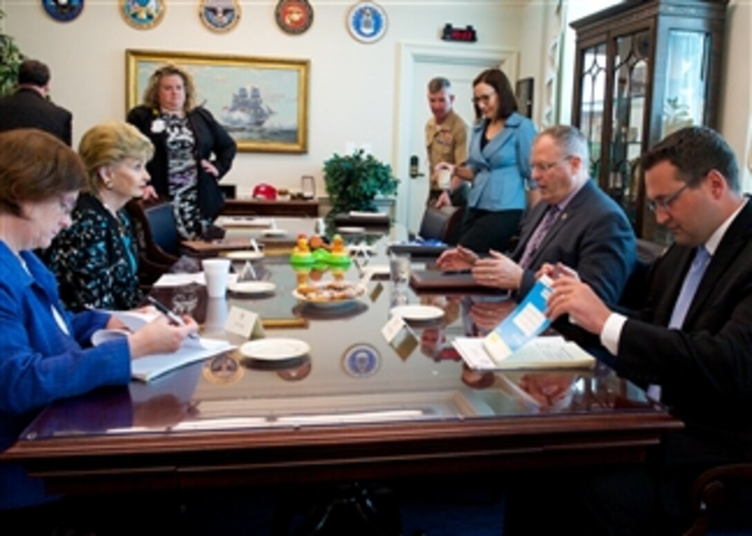 Deputy Defense Secretary Bob Work, center right, meets with U.S. Rep. Madeleine Bordallo of Guam, center left, at the Pentagon, Aug. 13, 2014.