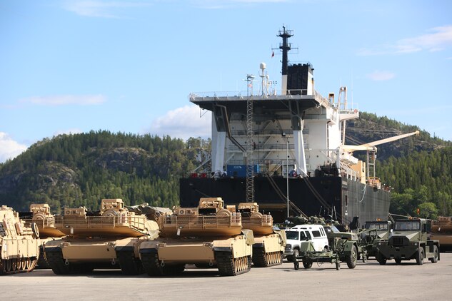 M1A1 Abrams Main Battle Tanks and other vehicles and equipment are staged for transportation at the designated offload pier during a pre-planned Single Ship Movement and offload of military equipment from a Maritime Prepositioning Force ship in the Trøndelag region of Norway.

U.S. Marines from 2nd Marine Logistics Group out of Camp Lejeune, NC, in coordination with their Norwegian counterparts, are modernizing some of the equipment currently stored within six caves as a part of the Marine Corps Prepositioning Program-Norway by placing approximately 350 containers of gear and nearly 400 pieces of heavy rolling stock into the storage caves.   

Specific equipment which will greatly increase the program’s readiness includes M1A1 Main Battle Tanks, Tank Retrievers, Armored Breeching Vehicles, Amphibious Assault Vehicles, Expanded Capacity Vehicle (ECV) Gun Trucks and several variants of the MTVR 7 ½ ton trucks.  

Planning for this equipment refresh began in the spring of 2010.