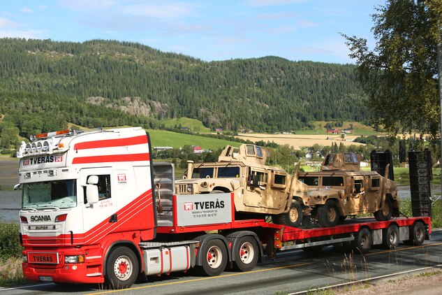 Armored variants of the M1114 High Mobility Multipurpose Wheeled Vehicle (HMMWV) are transported by truck from a ship offload location to one of six caves which make up the Marine Corps Prepositioning Program-Norway during an equipment modernization operation.

U.S. Marines from 2nd Marine Logistics Group out of Camp Lejeune, NC, in coordination with their Norwegian counterparts, are modernizing some of the equipment by placing approximately 350 containers of gear and nearly 400 pieces of heavy rolling stock into the storage caves.  

  Specific equipment which will greatly increase the program’s readiness includes M1A1 Main Battle Tanks, Tank Retrievers, Armored Breeching Vehicles, Amphibious Assault Vehicles, Expanded Capacity Vehicle (ECV) Gun Trucks and several variants of the MTVR 7 ½ ton trucks.  

Planning for this equipment refresh began in the spring of 2010.