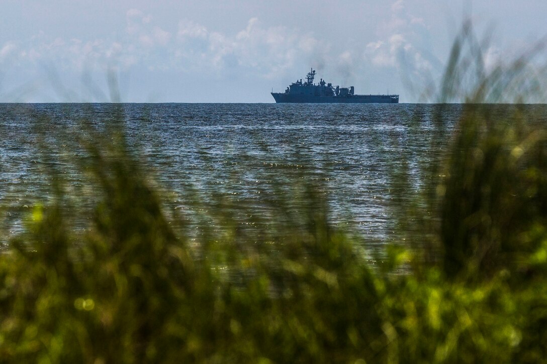 The USS Fort McHenry anchors off the shore of North Carolina while conducting tactical offload of 24th Marine Expeditionary Unit personnel and equipment, August 12, 2014. The offload was part of Amphibious Squadron/Marine Expeditionary Unit Integration, the second major exercise for the 24th MEU. The USS Fort McHenry is part of the Iwo Jima Amphibious Ready Group. (U.S. Marine Corps photo by Cpl. Mary M. Carmona)