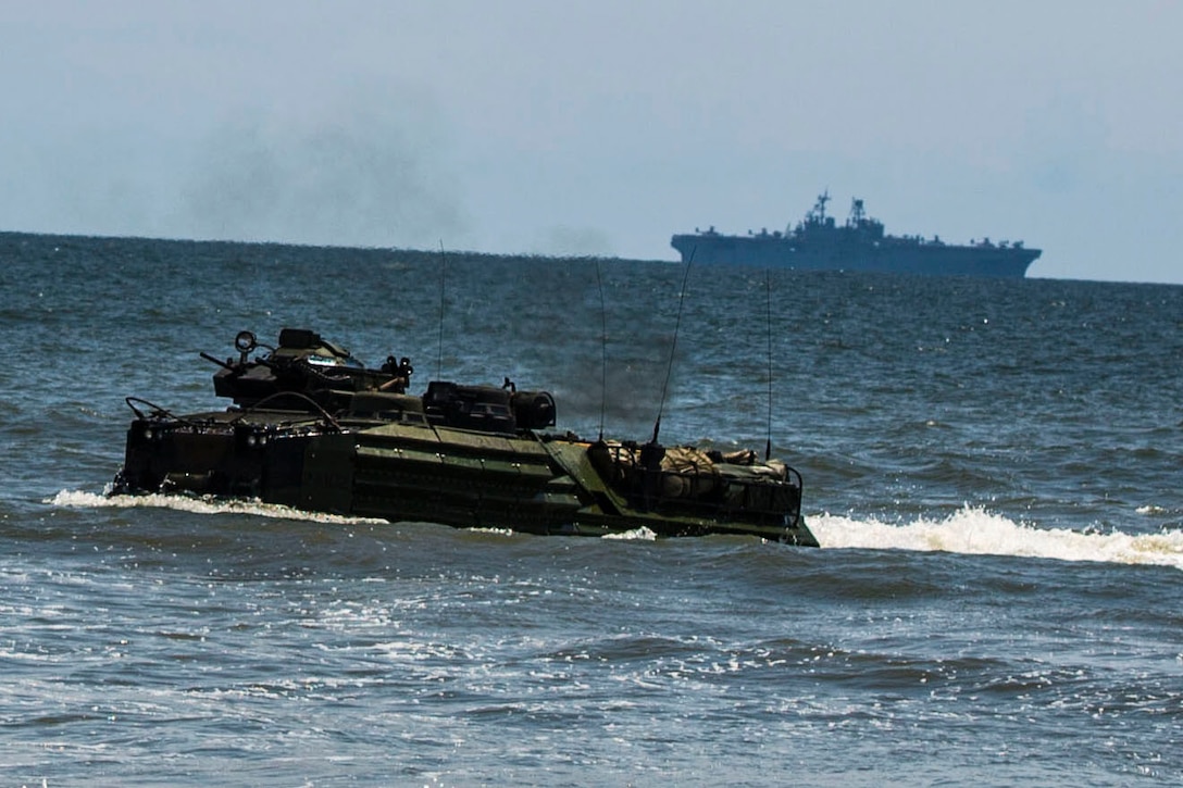 An amphibious assault vehicle with the 24th Marine Expeditionary Unit’s Ground Combat Element, Battalion Landing Team 3rd Battalion, 6th Marine Regiment, approaches Onslow Beach, N.C., during a tactical offload, August 12, 2014. The offload was part of Amphibious Squadron/Marine Expeditionary Unit Integration, the second major exercise for the 24th MEU. AAV’s were launched from the Iwo Jima Amphibious Ready Group’s USS Fort McHenry. (U.S. Marine Corps photo by Cpl. Mary M. Carmona)