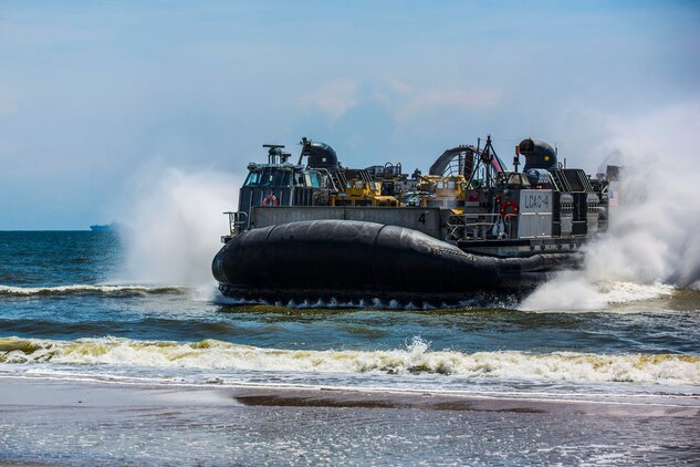 A Landing Craft Air Cushion, or LCAC, from Assault Craft Unit 4 conducting operations from the USS Iwo Jima, approaches Onslow Beach, N.C., during a tactical offload of 24th Marine Expeditionary Unit personnel and equipment, August 12, 2014. The offload was part of Amphibious Squadron/Marine Expeditionary Unit Integration, the second major exercise for the 24th MEU. The USS Iwo Jima is part of the Iwo Jima Amphibious Ready Group. (U.S. Marine Corps photo by Cpl. Mary M. Carmona)
