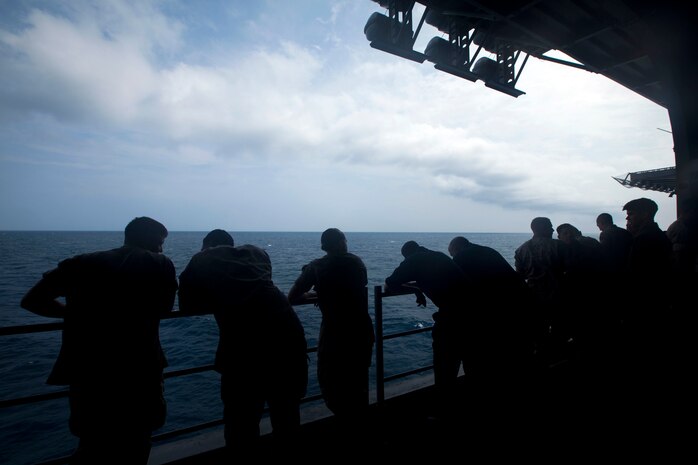 Marines and Sailors with the 24th Marine Expeditionary Unit and USS Iwo Jima Amphibious Ready Group enjoy the view from the hangar bay of the USS Iwo Jima off the coast of North Carolina August 8, 2014. The 24th MEU is taking part in Amphibious Squadron/ Marine Expeditionary Unit Integration, or PMINT, the 24th MEU’s second major pre-deployment training exercise. PMINT is designed to bring Marines and Sailors from the 24th MEU and Amphibious Squadron 8 together for the first time aboard the ships of the Iwo Jima Amphibious Ready Group. (U.S. Marine Corps Photo by Cpl. Todd F. Michalek)