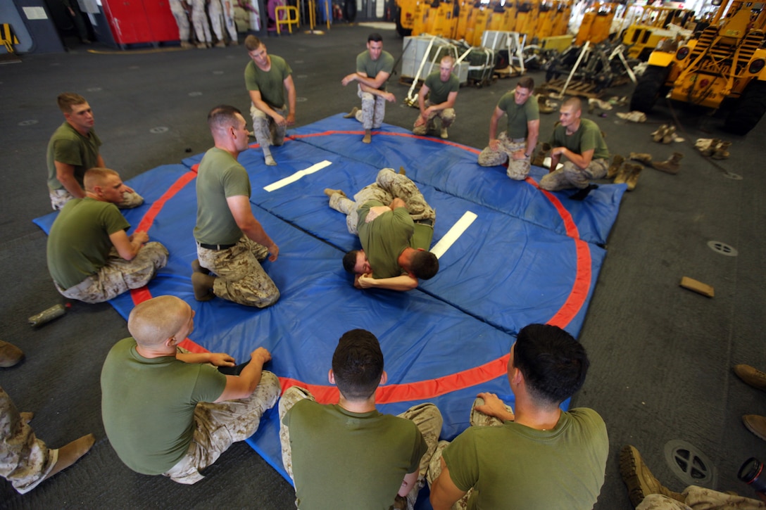 Marines with Battalion Landing Team 3rd Battalion, 6th Marine Regiment, 24th Marine Expeditionary Unit, practice grappling skills during part of Marine Corps Martial Arts Program, or MCMAP, training aboard the USS Iwo Jima, August 8, 2014, off the coast of North Carolina. The 24th MEU is taking part in Amphibious Squadron/ Marine Expeditionary Unit Integration, or PMINT, the 24th MEU’s second major pre-deployment training exercise. PMINT is designed to bring Marines and Sailors from the 24th MEU and Amphibious Squadron 8 together for the first time aboard the ships of the Iwo Jima Amphibious Ready Group. (U.S. Marine Corps Photo by Cpl. Todd F. Michalek)