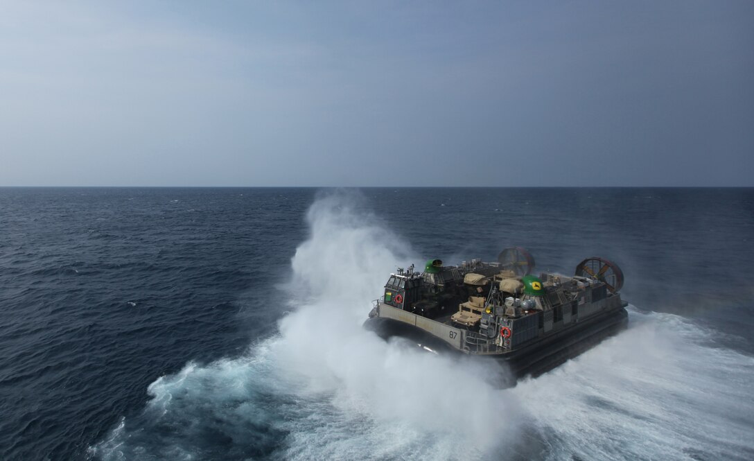 A Landing Craft, Air-Cushion, or LCAC, approaches the USS Iwo Jima August 8, 2014, off the coast of North Carolina. The LCAC carried 24th Marine Expeditionary Unit vehicles and equipment from shore to ship during Amphibious Squadron/Marine Expeditionary Unit Integration, or PMINT, the 24th MEU’s second major pre-deployment training exercise. PMINT is designed to bring Marines and Sailors from the 24th MEU and Amphibious Squadron 8 together for the first time aboard the ships of the Iwo Jima Amphibious Ready Group. (U.S. Marine Corps Photo by Cpl. Todd F. Michalek) 