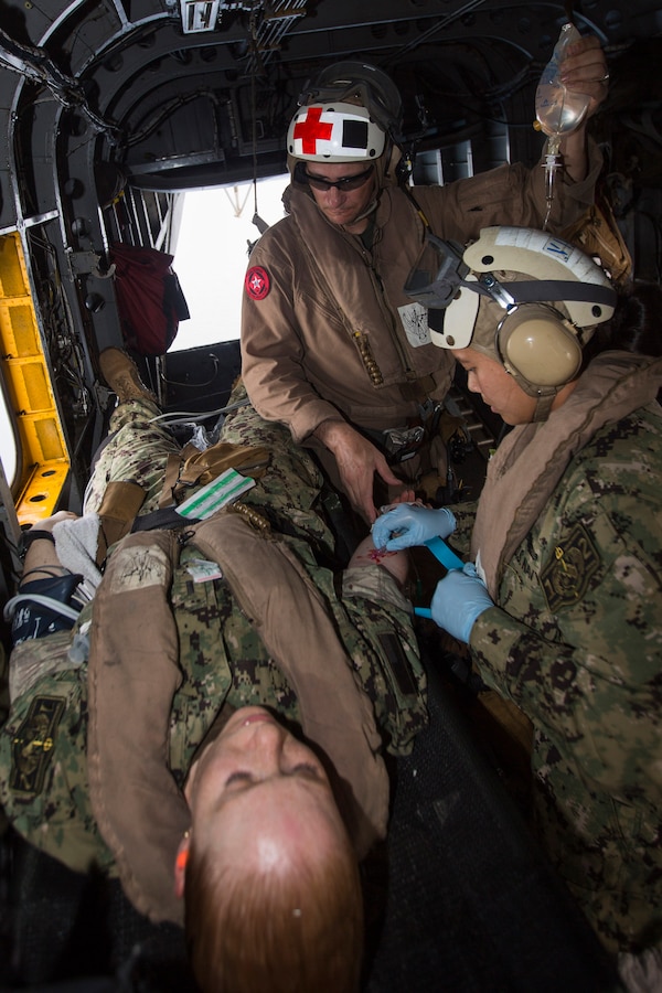 U.S. 5TH FLEET AREA OF RESPONSIBILITY (Aug. 4, 2014) U.S. Navy Lt. J.G. Jennifer Tran, right, Expeditionary Resuscitative Surgical System (ERSS) Team 12 critical care nurse and native of Fairfax, Va., and Hospital Corpsman Chief Jonathan Tarkowski, Marine Medium Tiltrotor Squadron (VMM) 263 (Reinforced), 22nd Marine Expeditionary Unit (MEU), medical chief and native of Tulsa, Okla., treat a simulated patient aboard a CH-53E Super Stallion during a tactical evacuation drill. The 22nd MEU is deployed with the Bataan Amphibious Ready Group as a theater reserve and crisis response force throughout U.S. Central Command and the U.S. 5th Fleet area of responsibility. (U.S. Marine Corps photo by Cpl. Manuel A. Estrada/Released)