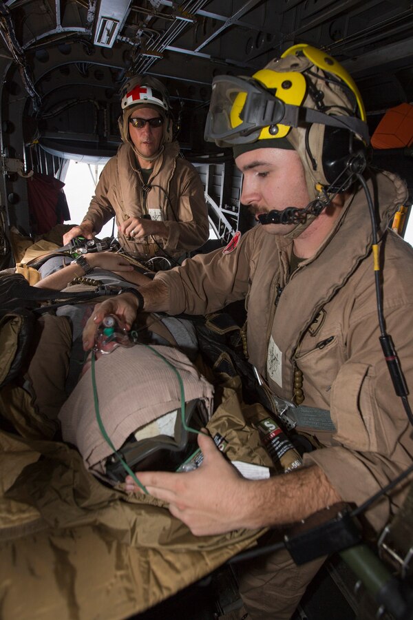 U.S. 5TH FLEET AREA OF RESPONSIBILITY (Aug. 4, 2014) U.S. Navy Hospital Corpsman 2nd Class Matthew Slosman, right, Marine Medium Tiltrotor Squadron (VMM) 263 (Reinforced), 22nd Marine Expeditionary Unit (MEU), tactical evacuation corpsman and native of Fremont, Mich., and Hospital Corpsman Chief Jonathan Tarkowski,VMM-263 (Rien.) medical chief and native of Tulsa, Okla., treat a simulated patient aboard a CH-53E Super Stallion during a tactical evacuation drill. The 22nd MEU is deployed with the Bataan Amphibious Ready Group as a theater reserve and crisis response force throughout U.S. Central Command and the U.S. 5th Fleet area of responsibility. (U.S. Marine Corps photo by Cpl. Manuel A. Estrada/Released)