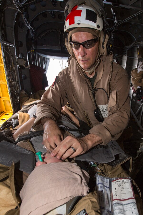 U.S. 5TH FLEET AREA OF RESPONSIBILITY (Aug. 4, 2014) U.S. Navy Hospital Corpsman Chief Jonathan Tarkowski, Marine Medium Tiltrotor Squadron (VMM) 263 (Reinforced), 22nd Marine Expeditionary Unit (MEU), medical chief and native of Tulsa, Okla., treats a simulated patient aboard a CH-53E Super Stallion during a tactical evacuation drill. The 22nd MEU is deployed with the Bataan Amphibious Ready Group as a theater reserve and crisis response force throughout U.S. Central Command and the U.S. 5th Fleet area of responsibility. (U.S. Marine Corps photo by Cpl. Manuel A. Estrada/ Released)