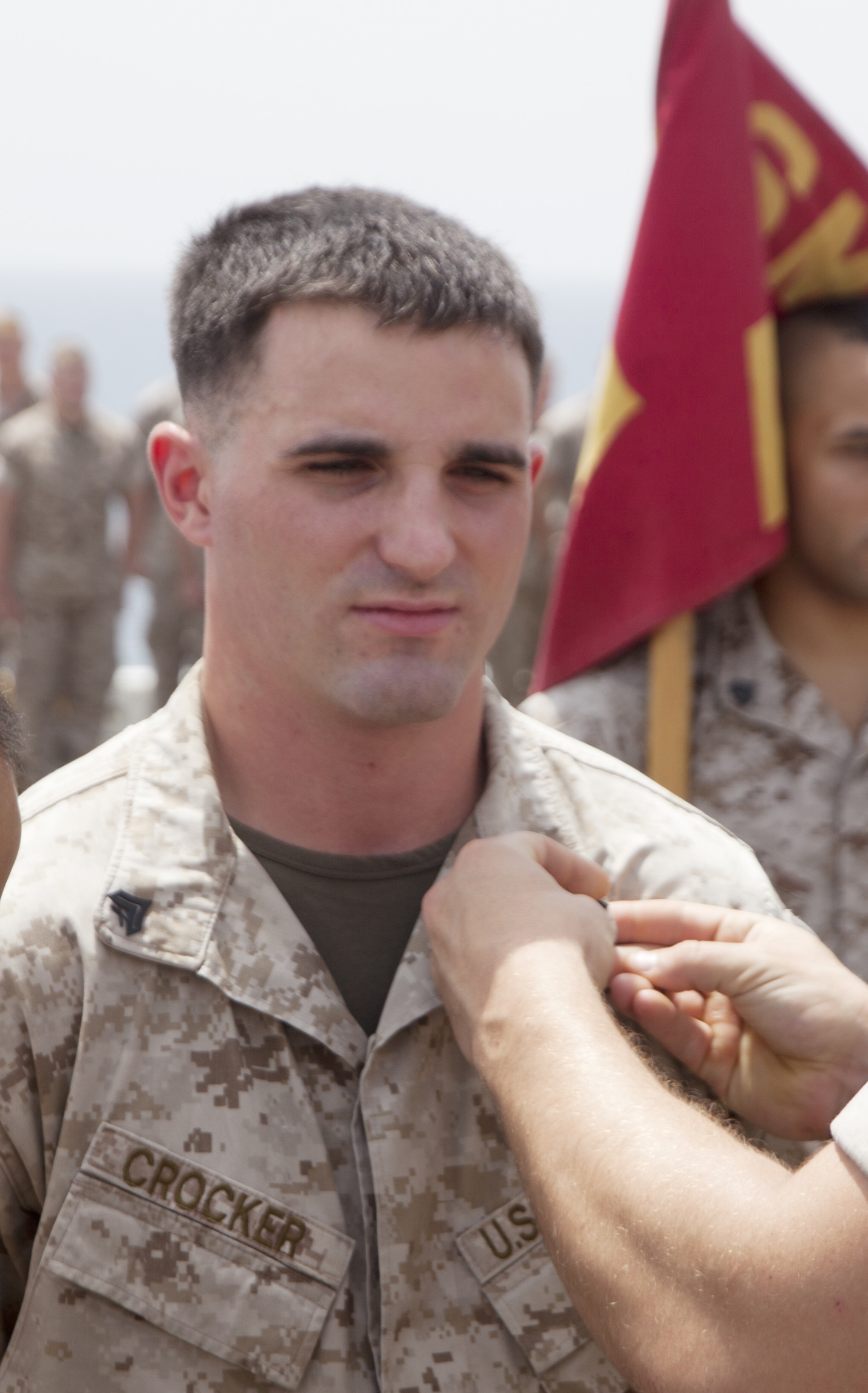 U.S. 5TH FLEET AREA OF RESPONSIBILITY (Aug. 1, 2014) A U.S. Marine with Battalion Landing Team (BLT) 1st Battalion, 6th Marine Regiment, 22nd Marine Expeditionary Unit (MEU), promotes Cpl. Briar Crocker, BLT 1/6 machine gunner and native of Byfield, Mass., to his current rank aboard the amphibious transport dock ship USS Mesa Verde (LPD 19). The 22nd MEU is deployed with the Bataan Amphibious Ready Group as a theater reserve and crisis response force throughout U.S. Central Command and the U.S. 5th Fleet area of responsibility. (U.S. Marine Corps photo by Staff Sgt. Lukas Atwell /Released)