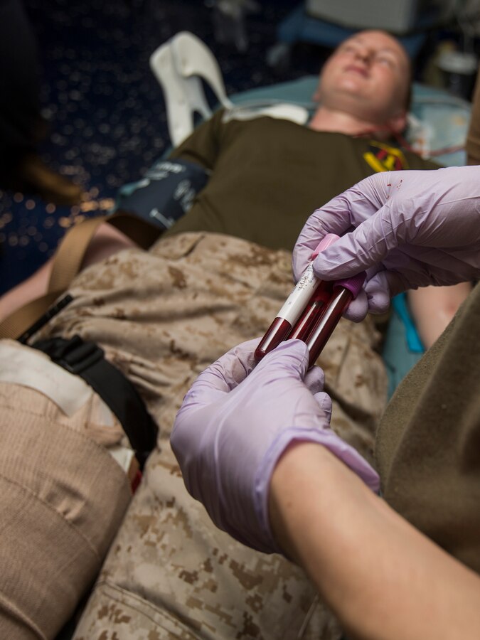 U.S. 5TH FLEET AREA OF RESPONSIBILITY (Aug. 7, 2014) A U.S. Navy Corpsman with the 22nd Marine Expeditionary Unit (MEU) draws several vials of blood from Cpl. Alicia Gouvea, Combat Logistics Battalion 22 motor transportation operator and native of Grand Rapids, Mich., during a mass causality drill aboard the amphibious transport dock ship USS Mesa Verde (LPD 19). The 22nd MEU is deployed with the Bataan Amphibious Ready Group as a theater reserve and crisis response force throughout U.S. Central Command and the U.S. 5th Fleet area of responsibility. (U.S. Marine Corps photo by Cpl. Manuel A. Estrada/Released)