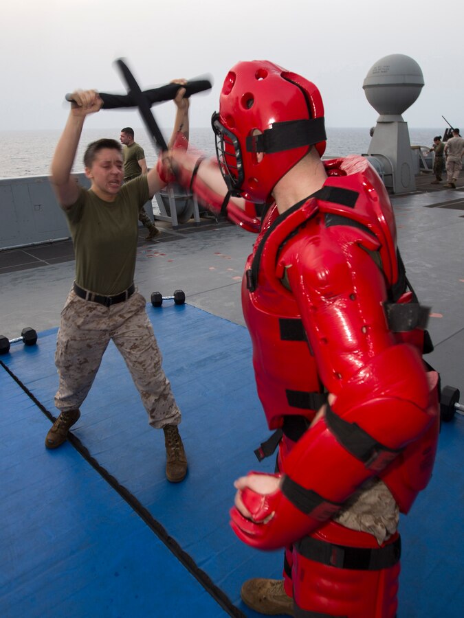 U.S. 5TH FLEET AREA OF RESPONSIBILITY (July 22, 2014) U.S. Marine Corps Sgt. Lauren Hall, Combat Logistics Battalion 22, 22nd Marine Expeditionary Unit (MEU), motor transportation maintenance chief and native of Cincinnati, blocks a strike from a simulated attacker after being sprayed with oleoresin capsicum (OC) spray, also known as “pepper spray,” as part of an OC spray qualification course aboard the amphibious transport dock ship USS Mesa Verde (LPD 19). The Marines were exposed to the OC spray in order to demonstrate its potential effects and to build confidence in their ability to fight through the effects of the spray. The 22nd MEU is deployed with the Bataan Amphibious Ready Group as a theater reserve and crisis response force throughout U.S. Central Command and the U.S. 5th Fleet area of responsibility. (U.S. Marine Corps photo by Cpl. Manuel A. Estrada/Released)