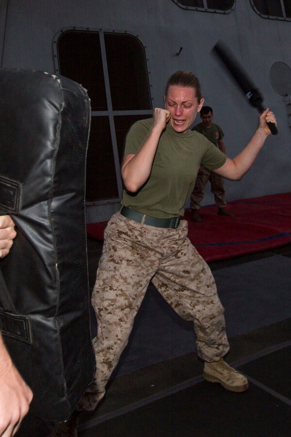 U.S. 5TH FLEET AREA OF RESPONSIBILITY (July 22, 2014) U.S. Marine Corps 1st Lt. Caitlin Powers, Combat Logistics Battalion 22, 22nd Marine Expeditionary Unit (MEU), logistics officer and native of Boca Raton, Fla., strikes a training pad after being sprayed with oleoresin capsicum (OC) spray, also known as “pepper spray,” as part of an OC spray qualification course aboard the amphibious transport dock ship USS Mesa Verde (LPD 19). The Marines were exposed to the OC spray in order to demonstrate its potential effects and to build confidence in their ability to fight through the effects of the spray. The 22nd MEU is deployed with the Bataan Amphibious Ready Group as a theater reserve and crisis response force throughout U.S. Central Command and the U.S. 5th Fleet area of responsibility. (U.S. Marine Corps photo by Cpl. Manuel A. Estrada/Released)