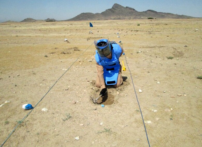 A contractor performs the dangerous work of manual munitions clearance activities on a range near Makuan in Afghanistan's Kandahar province in May. (Courtesy photo)