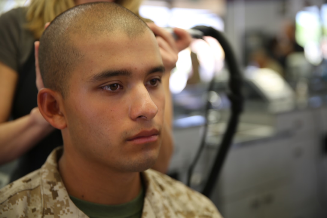 A recruit of Alpha Company, 1st Recruit Training Battalion, receives a haircut at Marine Corps Recruit Depot San Diego recruit barber shop, Aug. 7. After the recruits finished getting their haircuts, they continued with the day’s training.
