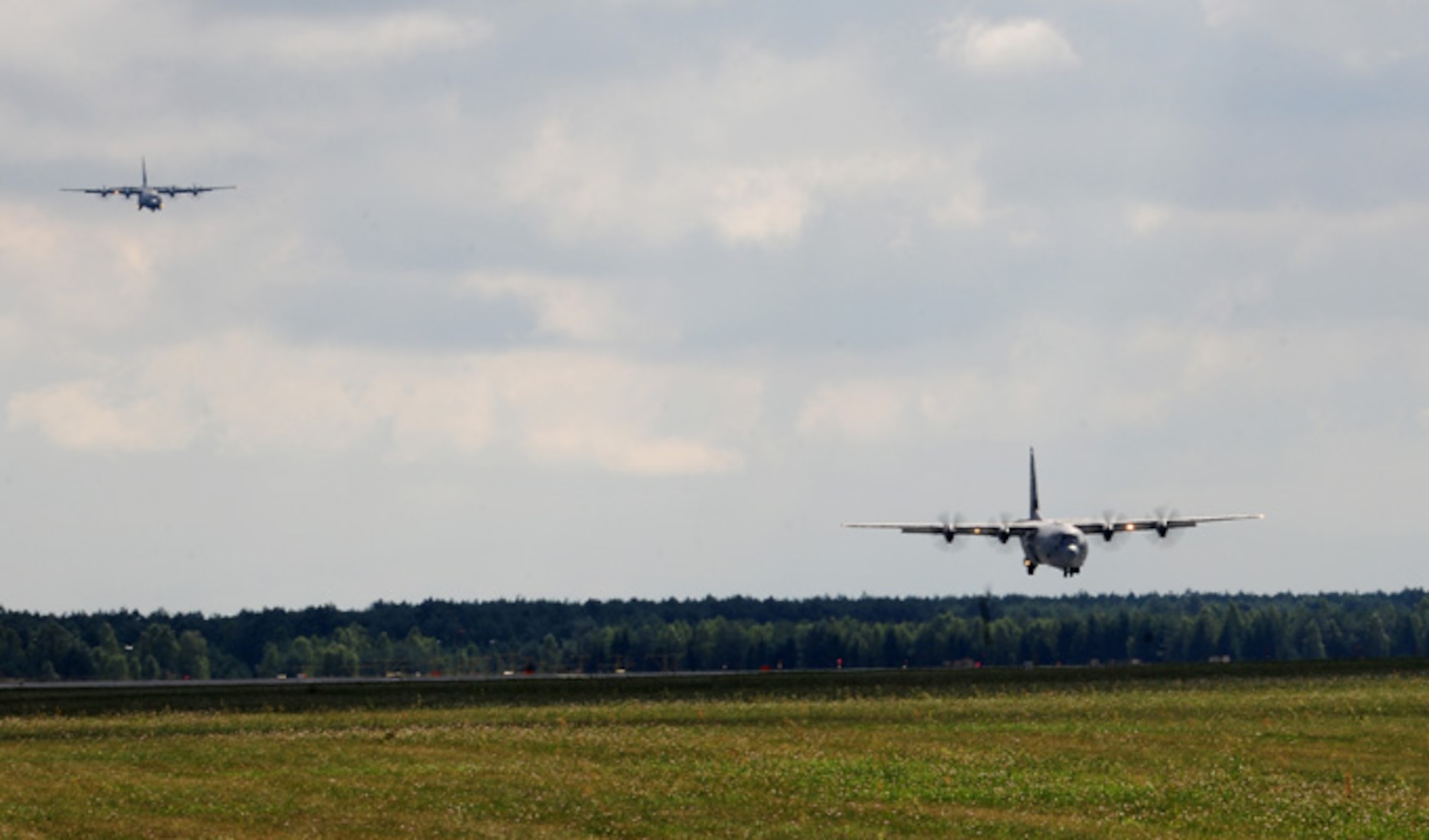 Two C-130J Super Hercules come in for a landing Aug. 14, 2014, at Powidz Air Base, Poland. The aircraft, deployed from Ramstein Air Base, Germany, are part of a training deployment in support of Operation Atlantic Resolve. (U.S. Air Force photo/Staff Sgt. Jarad A. Denton)
