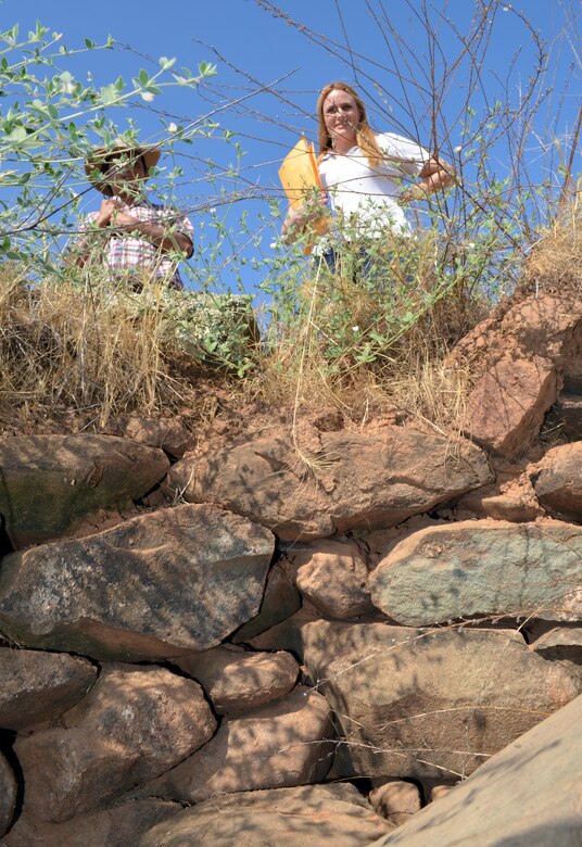 Lisa Westwood, ECORP Consulting archaeologist, stands above an abandoned well July 31, 2014, that was part of an 1800s inn that catered to miners outside today’s Northern California town of El Dorado Hills. ECORP has been contracted to help research and catalog historic sites on this project site.