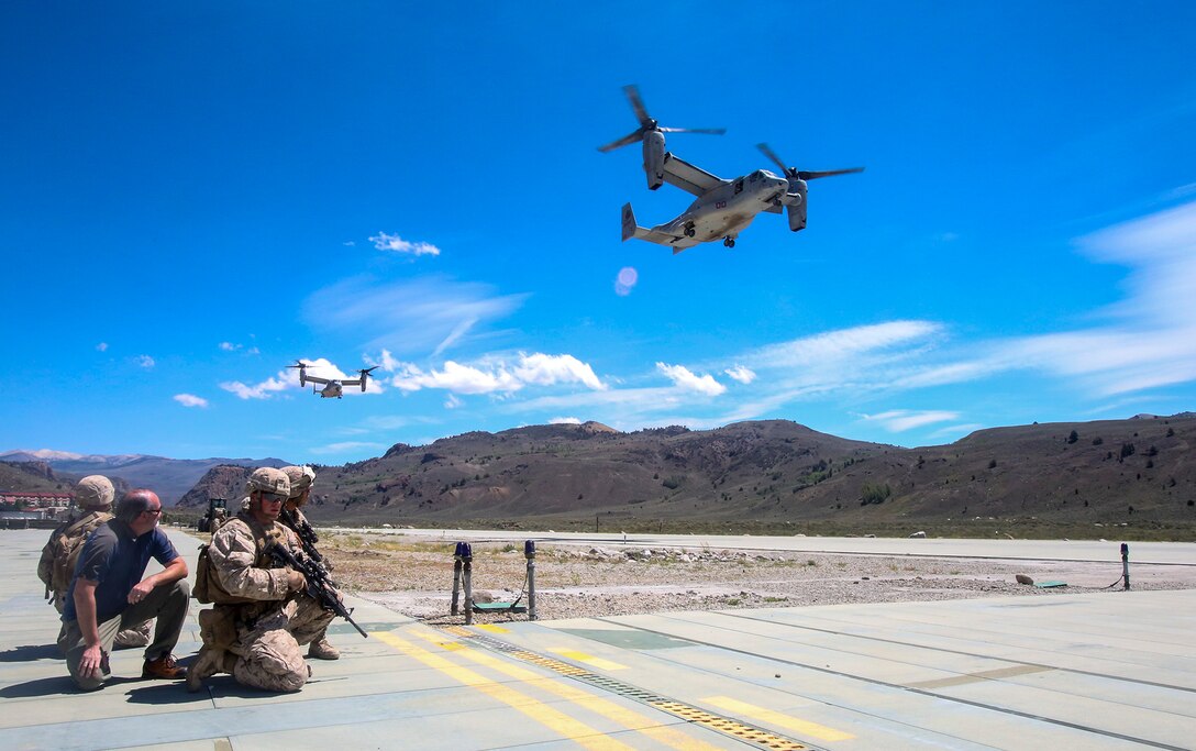 Marines with Company F, 2nd Battalion, 7th Marine Regiment, prepare to escort civilian personnel to board MV-22B Ospreys during a tactical non-combatant evacuation training mission at the Mountain Warfare Training Center in Bridgeport, Calif., Aug. 13, 2014. The Marines of 2nd Bn., 7th Marines, conducted the evacuation drill as part of Large Scale Exercise 2014. LSE-14 is a bilateral training exercise being conducted by 1st Marine Expeditionary Brigade to build U.S. and Canadian forces’ joint capabilities through live, simulated, and constructive military training activities from Aug. 8-14 aboard Marine Corps Air Ground Combat Center in Twentynine Palms, Calif.