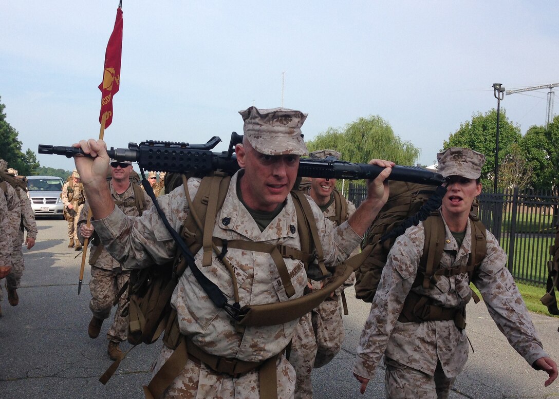 CHESAPEAKE, Va (Aug. 8, 2014 – Staff Sgt. James Adams, a career planner for Headquarters and Service Battalion, U.S. Marine Corps Forces Command (MARFORCOM) carries an M-240B Medium Machine Gun during a 5 mile hike aboard the Naval Support Activity Hampton Roads Northwest Annex Aug. 8. After the hike, the Marines of MARFORCOM completed weapons handling drills, combat pistol program shoot (along with a optional pistol qualification course of fire) barbeque and an MV-22 Osprey extract (U.S. Marine Corps photos by Staff Sgt. Christina Champion)