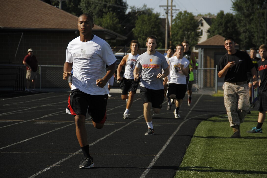 Blue Valley High School Tigers football players sprint around the track twice, simulating the movement-to-contact portion of the Marine Corps' combat Fitness Test, at the Lamar District Athletic Complex Aug. 14, 2014. Marines from Recruiting Station Kansas City and Recruiting Sub-Station Olathe were onhand to test the players mettle in a different way in preparation for the upcoming football season.
