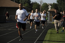 Blue Valley High School Tigers football players sprint around the track twice, simulating the movement-to-contact portion of the Marine Corps' combat Fitness Test, at the Lamar District Athletic Complex Aug. 14, 2014. Marines from Recruiting Station Kansas City and Recruiting Sub-Station Olathe were onhand to test the players mettle in a different way in preparation for the upcoming football season.