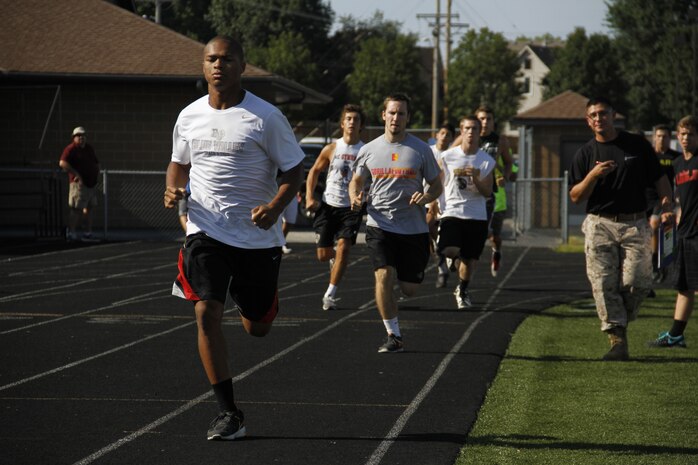 Blue Valley High School Tigers football players sprint around the track twice, simulating the movement-to-contact portion of the Marine Corps' combat Fitness Test, at the Lamar District Athletic Complex Aug. 14, 2014. Marines from Recruiting Station Kansas City and Recruiting Sub-Station Olathe were onhand to test the players mettle in a different way in preparation for the upcoming football season.