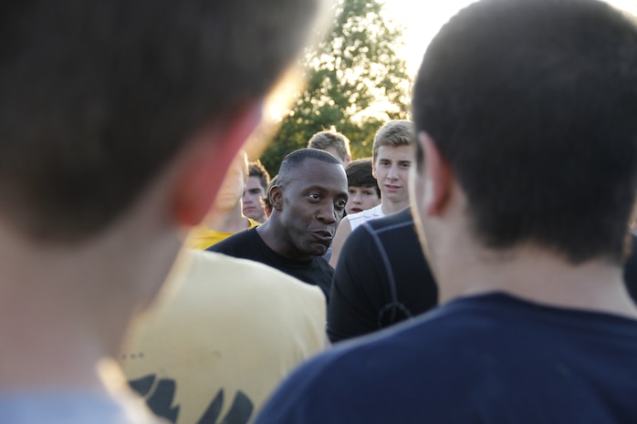 Sergeant Major Johnnie Hughes, Recruiting Station Kansas City sergeant major, motivates the Blue Valley High School Tigers football team after the team completed the Marine Corps' Combat Fitness Test at the Lamar District Athletic Complex Aug. 14, 2014. Hughes spoke of how elements of the CFT are meant to test one's will, determination, and perseverance, when tired and ready to quit.