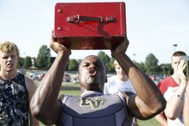 Gannon C. Cornley, a senior Blue Valley High School Tigers cornerback, running back, and wide receiver, exhales sharply as he presses a 30-pound ammunition can over his head during the Marine Corps' Combat Fitness Test as part of the Tigers offseason training at the Lamar District Athletic Complex Aug. 14, 2014. Marines from Marine Corps Recruiting Sub-Station Olathe were on hand to administer and supervise the CFT. Cornley performed more than 140 ammo-can lifts in the alloted two minutes. 