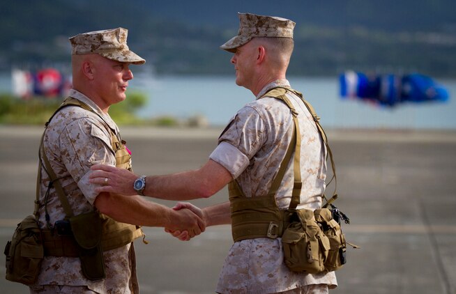 MARINE CORPS AIR STATION KANEOHE BAY - Col. Brian P. Annichiarico (left) and Col. Eric W. Schaefer exchange congratulations just after Annichiarico relinquished command of Marine Corps Base Hawaii to Schaefer during a change of command ceremony at Hangar 101 aboard Marine Corps Air Station Kaneohe Bay, Aug. 13, 2014. (U.S. Marine Corps photo by Lance Cpl. Aaron S. Patterson)